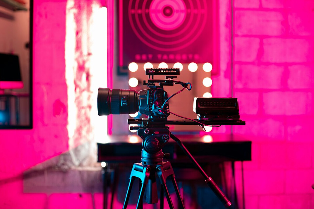 Television news studio set with multiple cameras and anchor desk