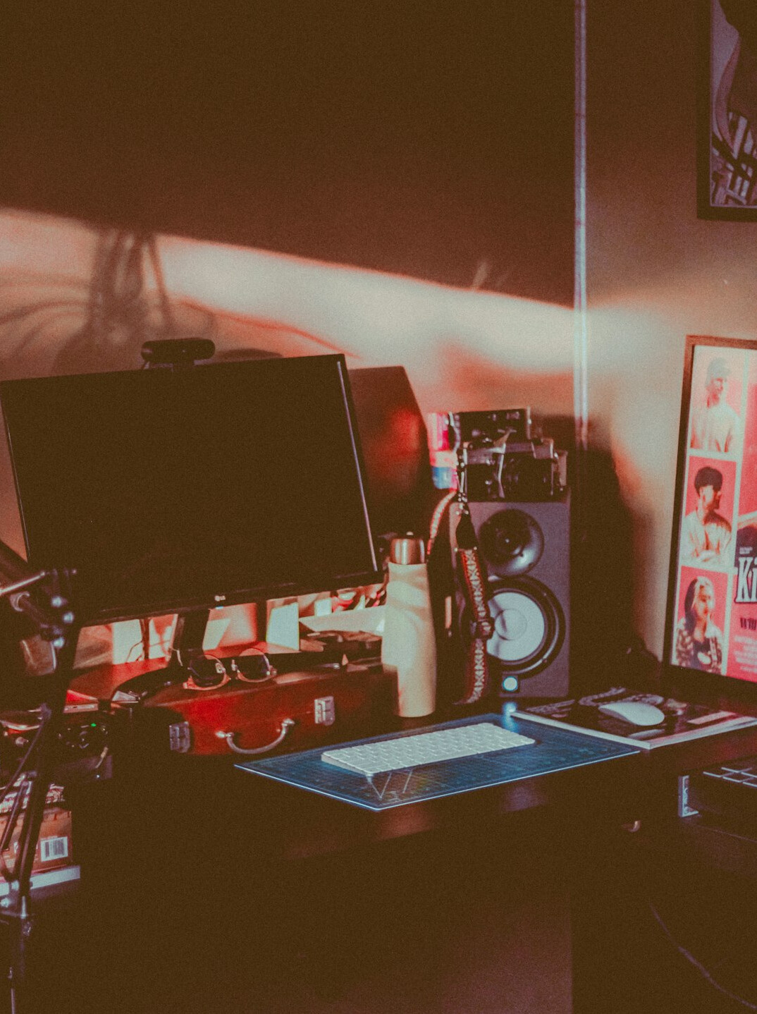 Video editor working on post-production editing suite with multiple monitors