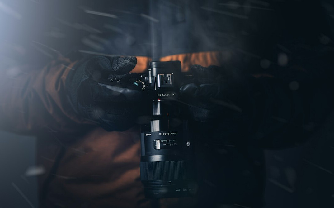 Camera operator filming a live television broadcast with a professional broadcast camera